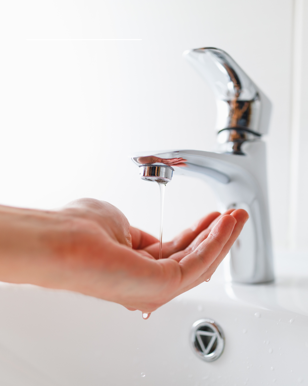 Low water pressure from a bathroom faucet with a weak stream of water flowing into a homeowner’s hands.