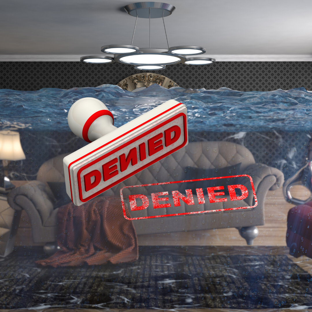 Flooded living room with water damage and denied insurance claim stamps showing plumbing leak coverage denial